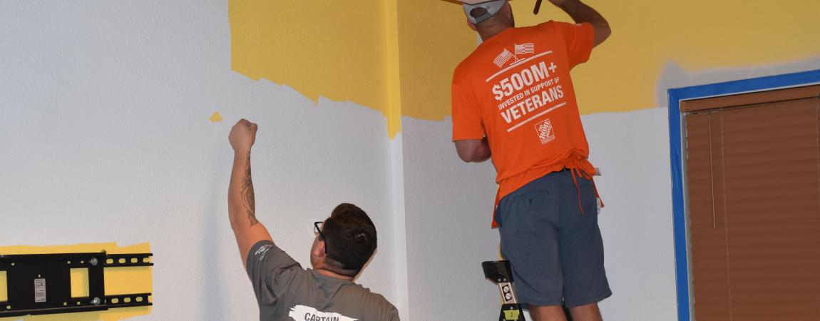 Home Depot workers painting a wall 