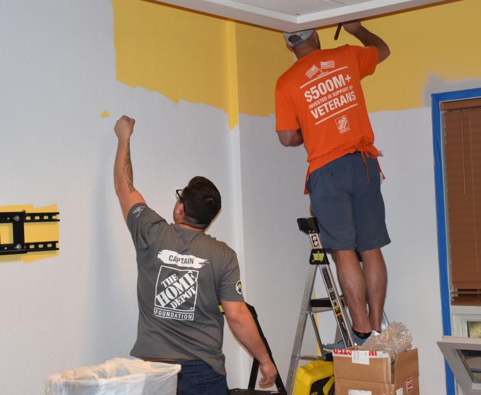 Home Depot workers painting a wall 